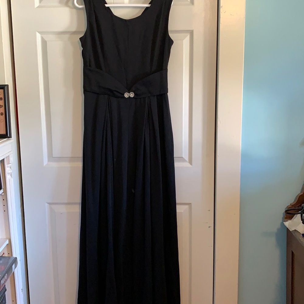 Simple black gown with embellished center.